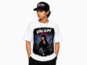 Male model wearing a white graphic T-shirt featuring a neon cityscape and 'VALIUM 2130' text, with a black cap visible.