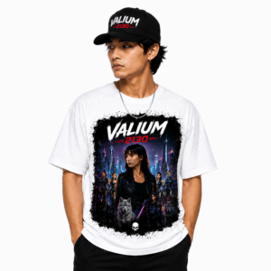 Male model wearing a white graphic T-shirt featuring a neon cityscape and 'VALIUM 2130' text, with a black cap visible.