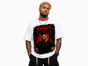 Man wearing a white graphic T-shirt with a bold red and black design featuring a dark-clad figure and the text 'The Sinner 2130'.