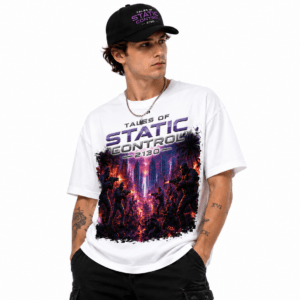 Man wearing a white graphic T-shirt with a neon purple cityscape battle design and the text 'Tales of Static Control' with a black cap on.